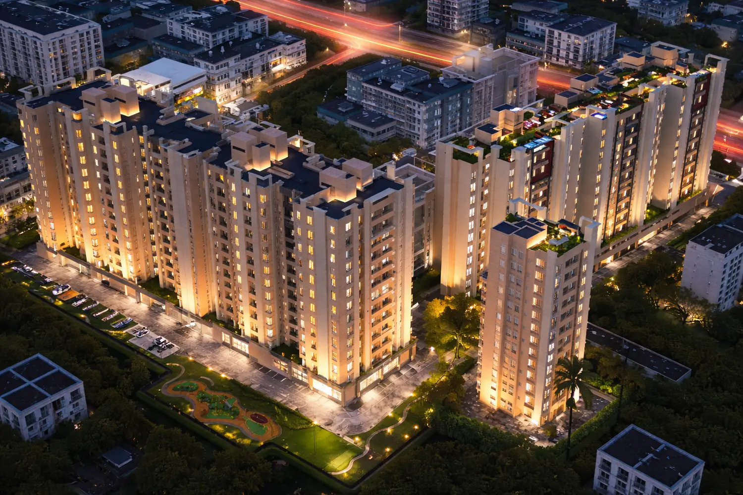 Aerial top view of the Ventoso residential project showcasing modern high-rise towers with rooftop amenities, landscaped terraces, a swimming pool, and surrounding green cover.